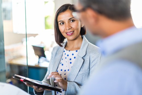 Two managers at a business talk about customer engagement and the communications layer.