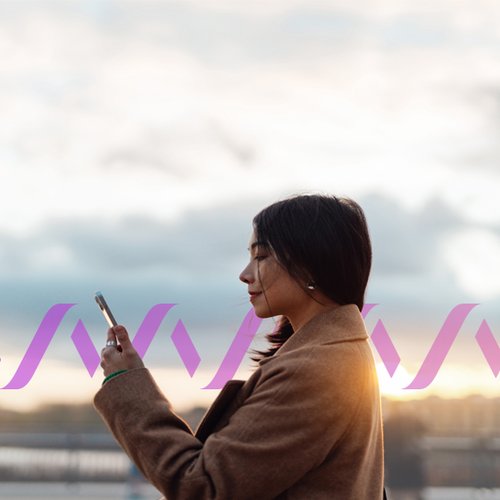 Confident young Asian businesswoman with smartphone standing against the sky. Concept of a Rich Communication Services message.