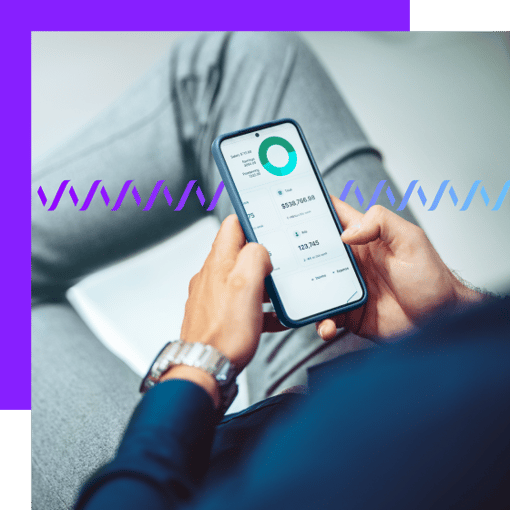 Close-up over-the-shoulder of a man engaging in online banking on his cell phone.  In the background, a series of small gradient blue waveforms run across the frame.