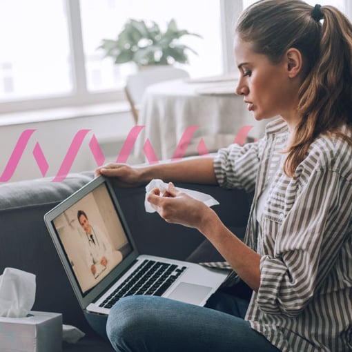 Ambient-Scribe-Telehealth-Blog.jpg Image of woman, sitting with a laptop. She’s holding a tissue and conducting a virtual doctor’s visit.