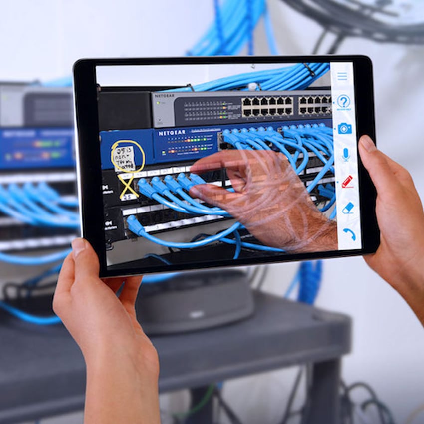 Woman looking at phone while fixing equipment