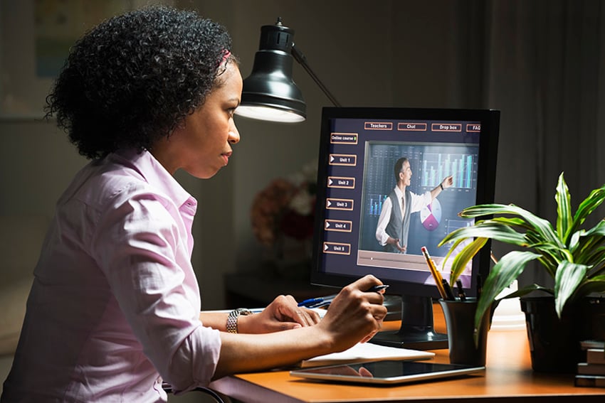 Student at desk computer looking at eLearning lesson on screen