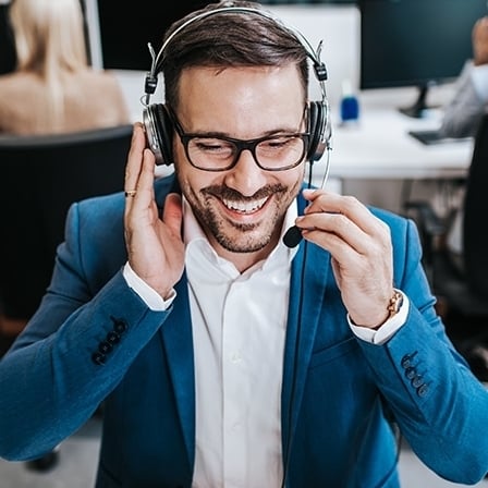 1180054097 Handsome male customer service agent working in call centre office as a telemarketer.