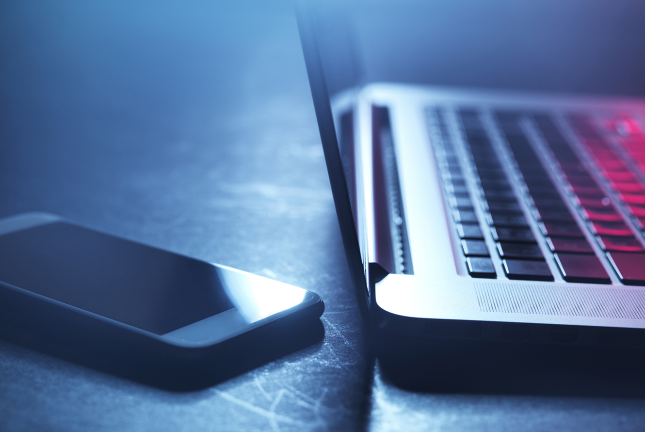 Laptop and smartphone at night